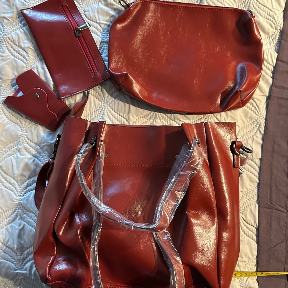 Chestnut leather like handbag with accessory pouches.